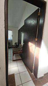 a living room with a black door and a couch at descanso del viajero habitacion confortable in Veracruz +1 photo