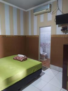 Postel nebo postele na pokoji v ubytování Pemda 22 Mansion