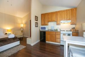 a kitchen with wooden cabinets and a bed in a room at Sonoma Getaway for Two - Great Location in Sonoma