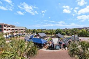 an aerial view of a resort with palm trees at The Village Blue Haven Condo - Private Beach Access Pool & Hot Tub in Rosemary Beach
