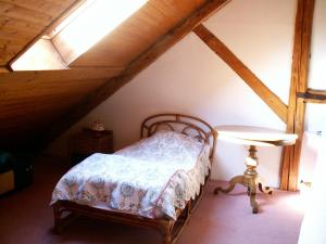 ein Schlafzimmer mit einem Bett auf einem Dachboden in der Unterkunft La grange in Menthon-Saint-Bernard