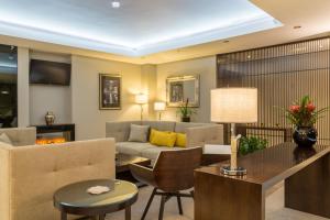 a living room with a couch and a table at Mansio Suites The Headrow in Leeds