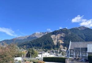 a view of a town with mountains in the background at Central City Queenstown Retreat - 3 Bedroom Apartment in Queenstown