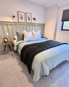 a bedroom with a large bed with pillows at Central City Queenstown Retreat - 3 Bedroom Apartment in Queenstown