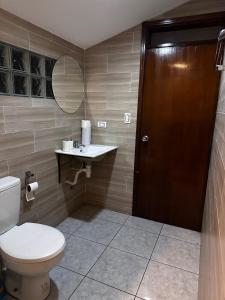 a bathroom with a toilet and a sink and a mirror at Departmento Ametauna in Santa Cruz de la Sierra