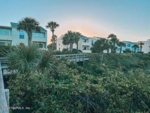 a group of houses on a hill with palm trees at Boutique Beachside condo with easy access to beach in Saint Augustine