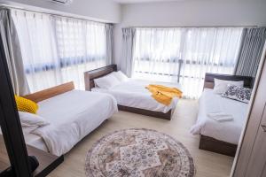Postel nebo postele na pokoji v ubytování ORI Nipponbashi