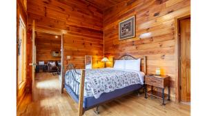 a bedroom with a bed in a room with wooden walls at Dream Circle in Bryson City