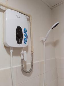 a soap dispenser on the wall of a bathroom at Oceanwhite Homestay Corus in Port Dickson +54 photos