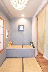 a room with a bench in the corner of a room at Ostay Ikebukuro Dairaku Hotel Apartment in Tokyo