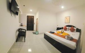 a bedroom with a bed and a chair in it at Blossoming Romduol Boutique in Siem Reap