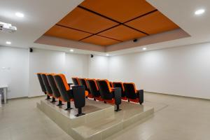 a row of chairs in a room with white walls at Apartasuite Sabaneta City view parking in Sabaneta +10 photos