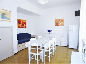 a kitchen and dining room with a table and chairs at Charming villa in Porto Santa Margherita with private garden in Porto Santa Margherita di Caorle