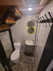 a small bathroom with a toilet and a sink at Penak hostel malioboro in Sentool