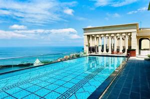 a swimming pool with a view of the ocean at Skyline Hillside Apartment Phu Quoc in Phú Quốc