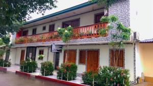 a building with a balcony with plants on it at Hotel Diamante in Saravena