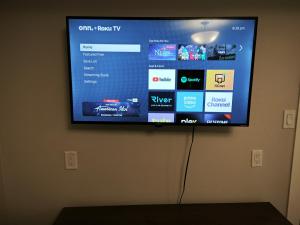 a flat screen tv hanging on a wall at Chamber Inn in Edmonton