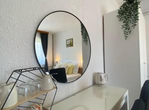 a mirror in a room with a table and a bed at M&N Zafran in Grabovac +22 photos