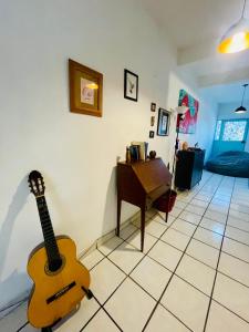 a guitar sitting on the floor in a living room at Casa Kante centro histórico 2bed 2Bath parking in San José del Cabo +56 photos