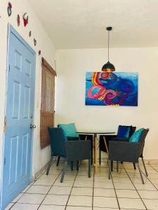 a dining room with a table with chairs and a painting at Casa Kante centro histórico 2bed 2Bath parking in San José del Cabo