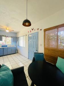 a living room with a table and a kitchen at Casa Kante centro histórico 2bed 2Bath parking in San José del Cabo