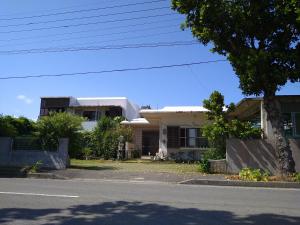 a house sitting on the side of a street at Minshuku Zabaru in Ishigaki Island