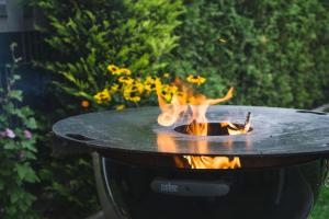 a barbecue grill with a fire in it at Landgasthaus Hotel Wolters in Kerken