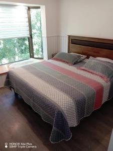 Postel nebo postele na pokoji v ubytování Departamento Pucon Parque + 5 fotografií