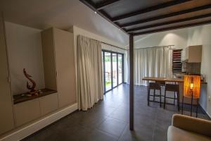 a living room with a table and a dining room at Peperu Lodge in Punaauia