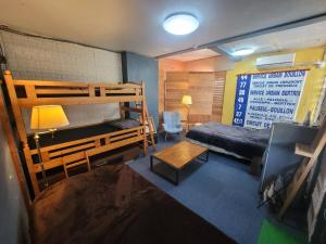 a bedroom with two bunk beds and a desk at Sara in Kagoshima
