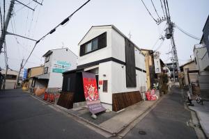 a white building on the side of a street at 伏見稲荷 -菊- in Kyoto