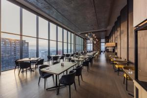 a restaurant with tables and chairs and large windows at The Gate Hotel Fukuoka by Hulic in Fukuoka +41 photos