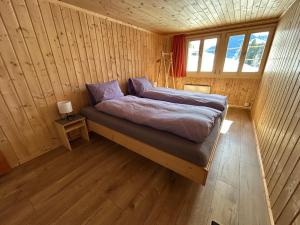 A bed or beds in a room at Alpenchalet Haldeli Ferienwohnung