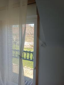 a door with a window with a view of a yard at La Réserve, Suite et SPA in Noyelles-sous-Bellonne