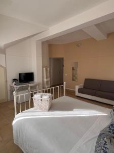 a living room with a large bed and a couch at Regina Margherita B&B in Marzamemi