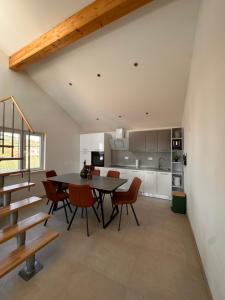 a dining room and kitchen with a table and chairs at Apartment Bunja No2 in Drage +31 photos