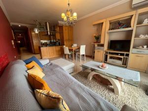 a living room with a couch and a table at Mellieha Beach Apt Terrace&Views in Mellieħa