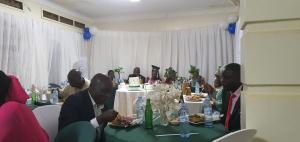 a group of people sitting at a table eating food at City Resort Executive Services in Seeta