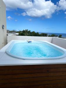 a jacuzzi tub sitting on top of a balcony at Salineo II Penthouse in Tamarin