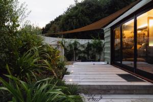 a house with a wooden walkway next to a building at The Carriage - Outdoor Private Bath in Closeburn