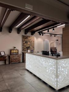 a kitchen with a large white counter in a room at Residenza Accademia, MantegnaHotels in Mantova