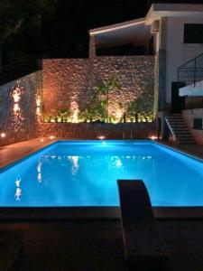 a large blue swimming pool at night with lights at VFH Residence Flavia -Tre Piscine in Santa Flavia