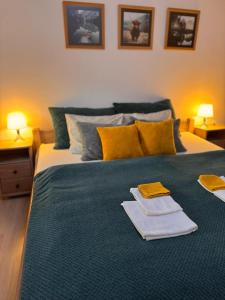 a bedroom with a bed with two towels on it at Wielkopolska 22 in Szczecin