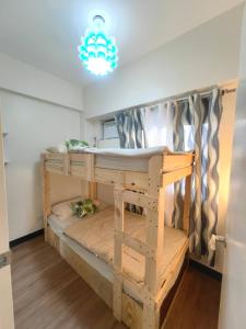 a bunk bed in a room with a chandelier at Jungle Escape in Manila