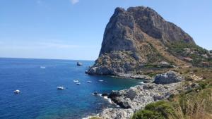 a group of boats in the water next to a mountain at VFH Residence Flavia -Tre Piscine in Santa Flavia