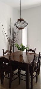 a dining room table with chairs and a pendant light at InnJoy Space in Glyfada