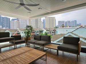 a patio with couches and a view of a city at Villa Homescape, Mont Kiara in Kuala Lumpur