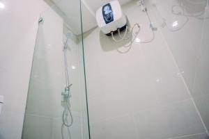 a shower with a shower head in a bathroom at Pleasurable and Tidy Studio Daan Mogot City Apartment By Travelio in Jakarta +9 photos