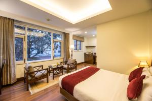 a hotel room with a bed and a window at Hotel Marshyangdi in Kathmandu