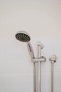 a shower with a shower head on a wall at Jewel on Lewis - Central Mudgee Haven near Wineries in Mudgee +24 photos